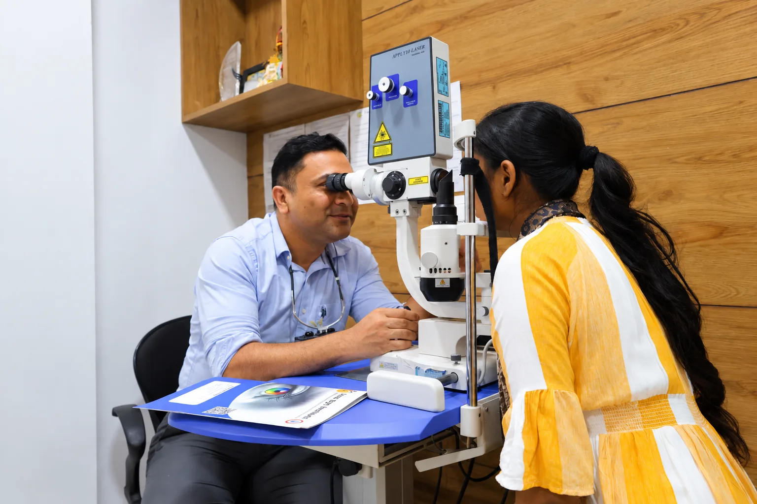 Patient undergoing an eye examination with ophthalmic equipment